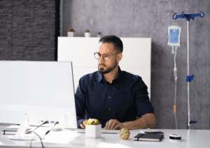 a Guy receiving IV Therapy from a Best DOC in his office