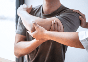 Man with a swelling on left hand and receiving physiotherapy for it