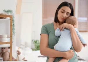 A lady in green top with her baby