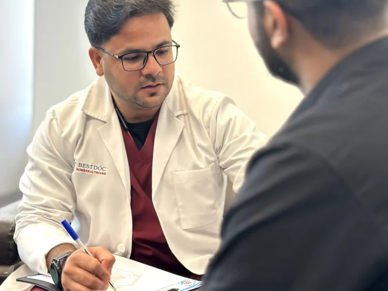 Dr Riyaz consulting a patient at their Home